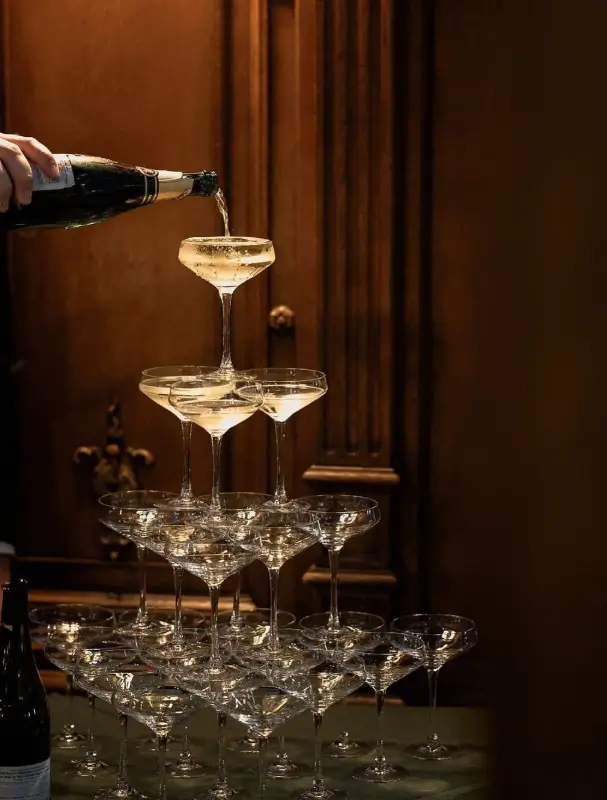Champagne tower being poured in a wood-panelled room — Homeland Ranjit Avenue launch hospitality, Amritsar