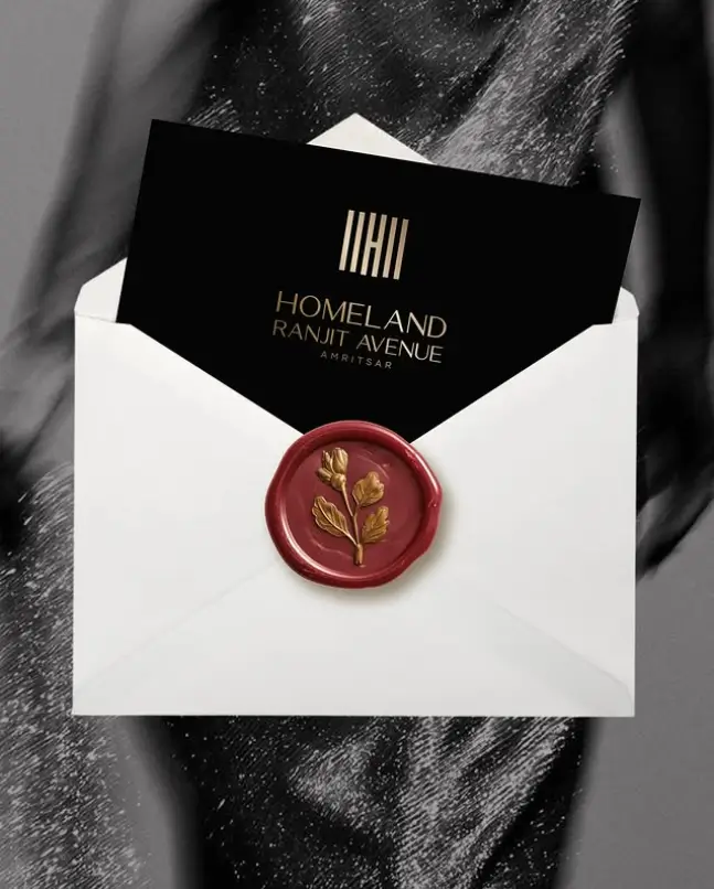 Black Homeland Ranjit Avenue invitation card with gold logo, wax-sealed envelope — Amritsar
